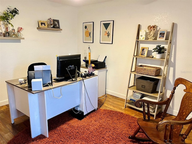 home office featuring wood finished floors and baseboards