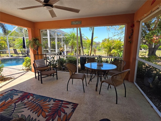 sunroom with a ceiling fan