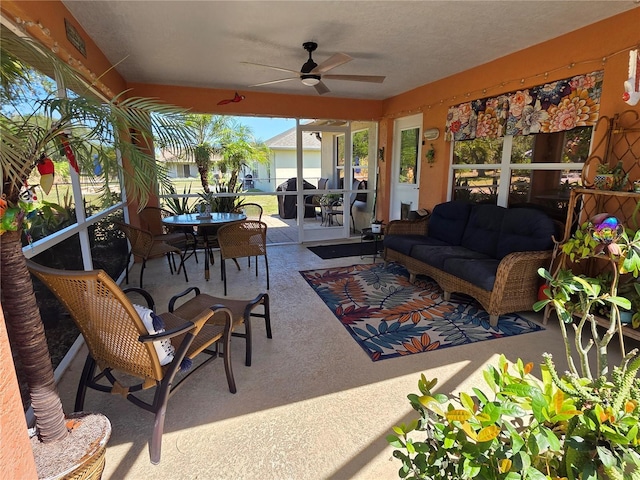 view of patio with an outdoor living space, outdoor dining space, and ceiling fan