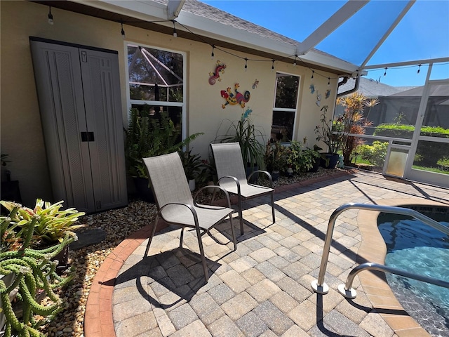 view of patio / terrace featuring an outdoor pool and glass enclosure