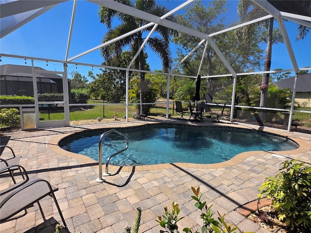 pool with a patio area and glass enclosure