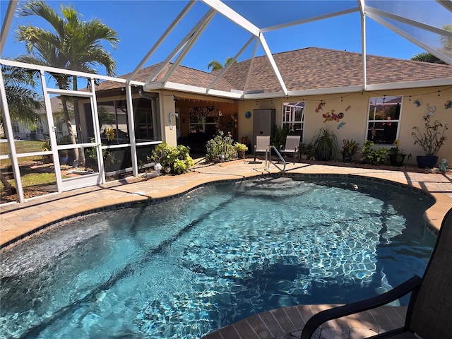 outdoor pool with a lanai and a patio area