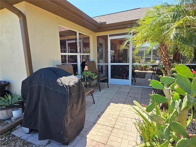 view of patio / terrace with a grill and a sunroom