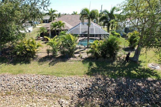 view of yard with an outdoor pool, fence private yard, and a lanai