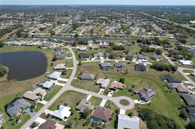 drone / aerial view with a residential view and a water view