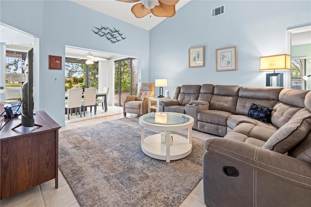 living room featuring light tile patterned floors, visible vents, high vaulted ceiling, and a ceiling fan