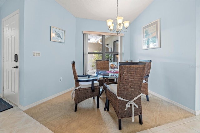 tiled dining room featuring an inviting chandelier and baseboards