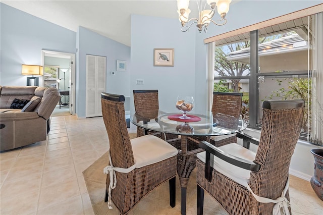 dining space with light tile patterned flooring, lofted ceiling, and an inviting chandelier