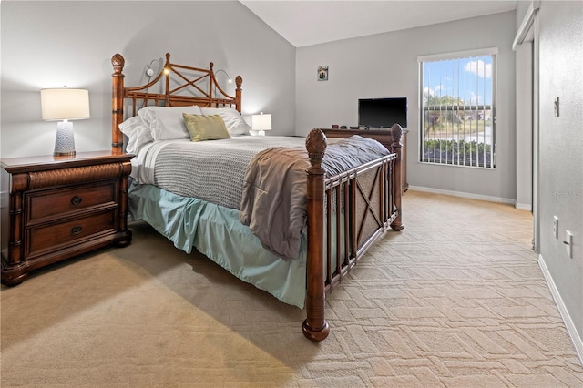 bedroom with baseboards, light colored carpet, and vaulted ceiling