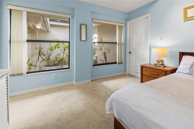 carpeted bedroom featuring baseboards