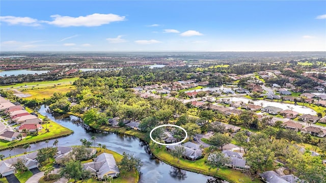 drone / aerial view featuring a residential view and a water view