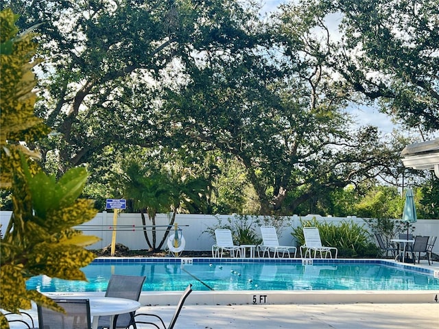 pool featuring a patio area and fence