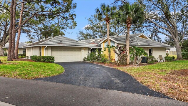 238 Southampton Dr Unit 319, Venice, FL 34293 - ranch-style home with an attached garage, stucco siding, asphalt driveway, and a front yard