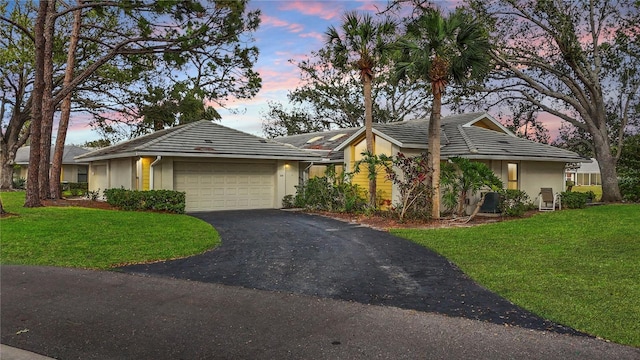 238 Southampton Dr Unit 319, Venice, FL 34293 - ranch-style house with stucco siding, an attached garage, asphalt driveway, and a yard