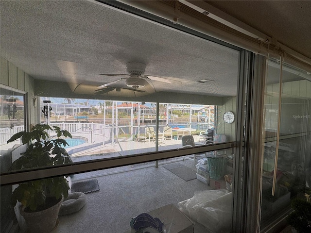 sunroom / solarium with a ceiling fan