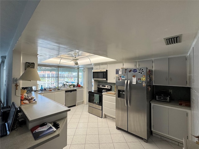 kitchen with light tile patterned floors, visible vents, a sink, appliances with stainless steel finishes, and tasteful backsplash