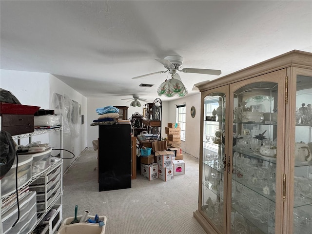 interior space featuring visible vents, carpet, and a ceiling fan