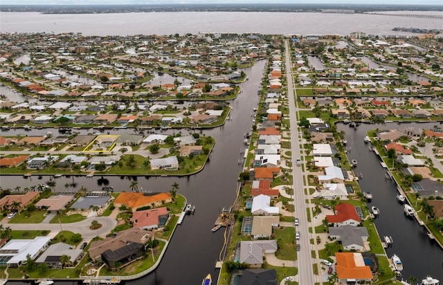 bird's eye view with a residential view and a water view