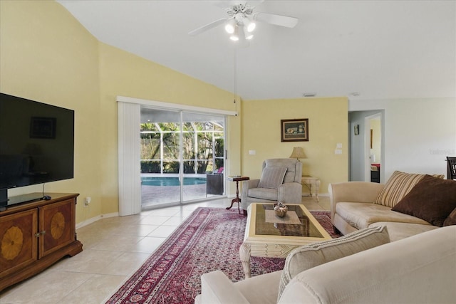 living area featuring light tile patterned floors, a ceiling fan, visible vents, baseboards, and lofted ceiling