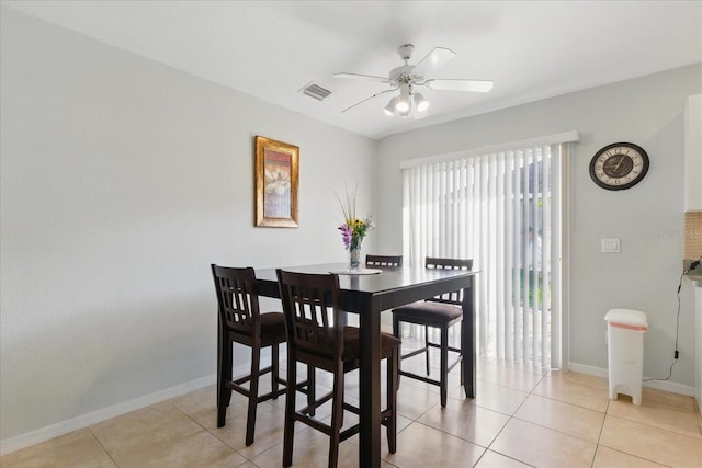 dining area with visible vents, baseboards, light tile patterned flooring, and a ceiling fan