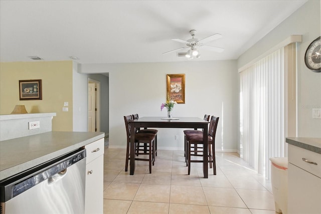 dining area with light tile patterned floors, visible vents, baseboards, and ceiling fan