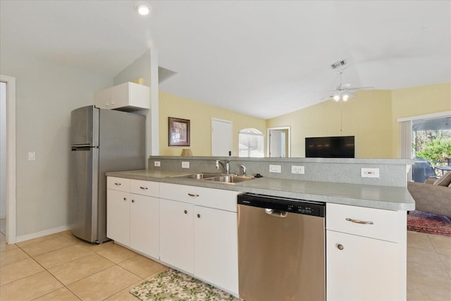 kitchen featuring a peninsula, a sink, stainless steel appliances, vaulted ceiling, and open floor plan