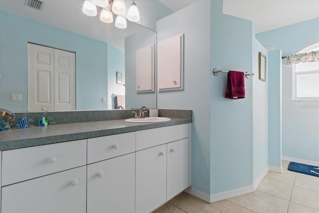 bathroom featuring tile patterned flooring, visible vents, baseboards, a chandelier, and vanity