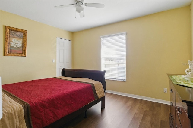 bedroom featuring a closet, baseboards, ceiling fan, and dark wood-style flooring