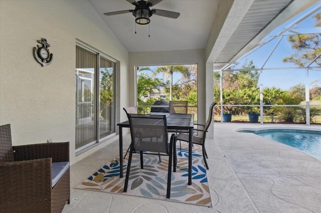 view of patio featuring a lanai, an outdoor pool, ceiling fan, and outdoor dining space