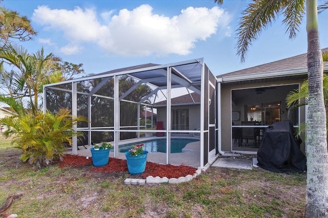 back of house featuring an outdoor pool, stucco siding, a lanai, and a patio area