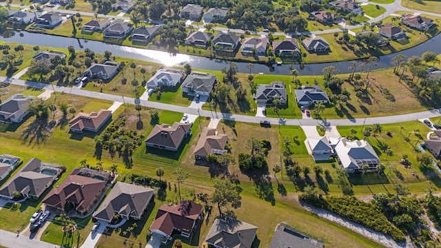 drone / aerial view featuring a residential view and a water view