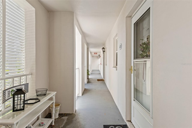 corridor with unfinished concrete flooring