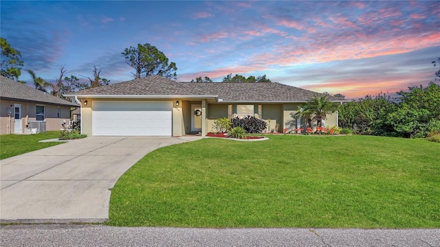 single story home featuring stucco siding, an attached garage, concrete driveway, and a front lawn