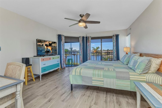 bedroom with wood finished floors, access to exterior, and a ceiling fan