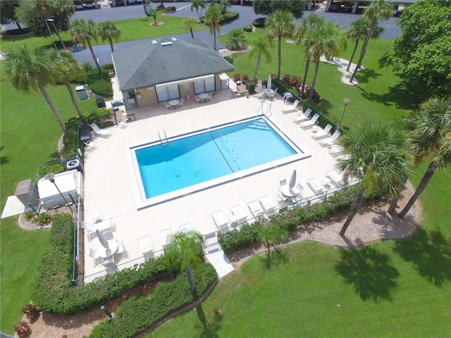 community pool featuring fence, a lawn, and a patio area