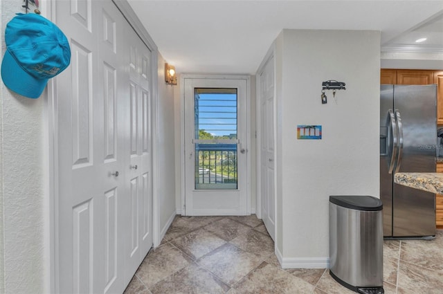 doorway featuring baseboards