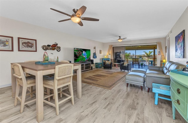 dining room featuring light wood-style floors and ceiling fan