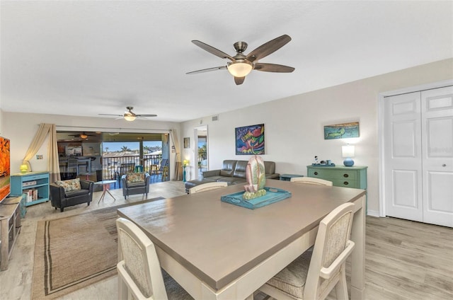 dining room with light wood-style flooring and ceiling fan