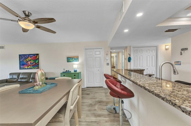 dining room with recessed lighting, a ceiling fan, visible vents, and light wood finished floors