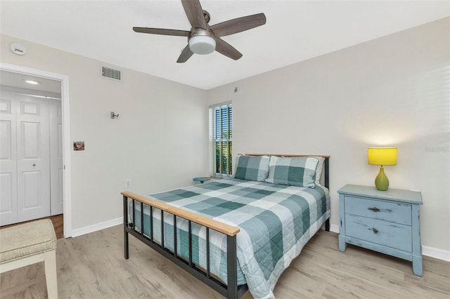 bedroom with visible vents, baseboards, ceiling fan, and light wood finished floors