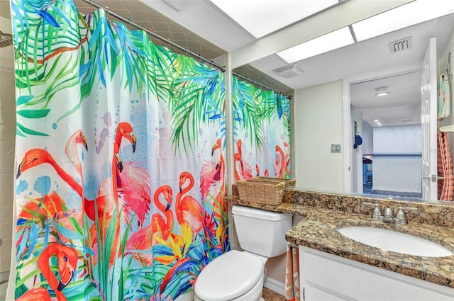 bathroom with vanity, a shower with shower curtain, toilet, and visible vents