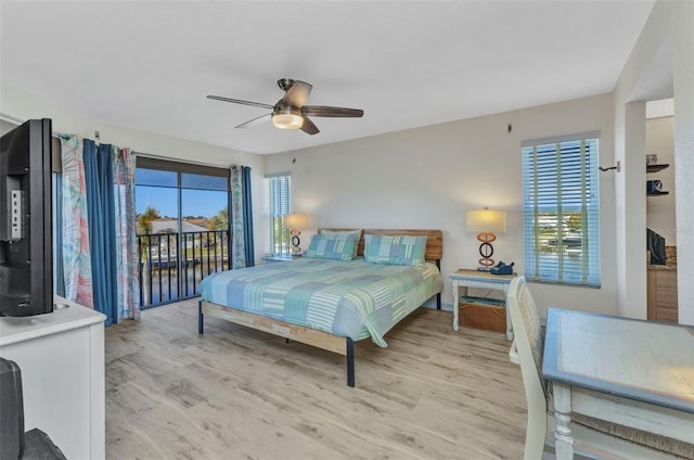 bedroom with access to outside, multiple windows, a ceiling fan, and light wood finished floors