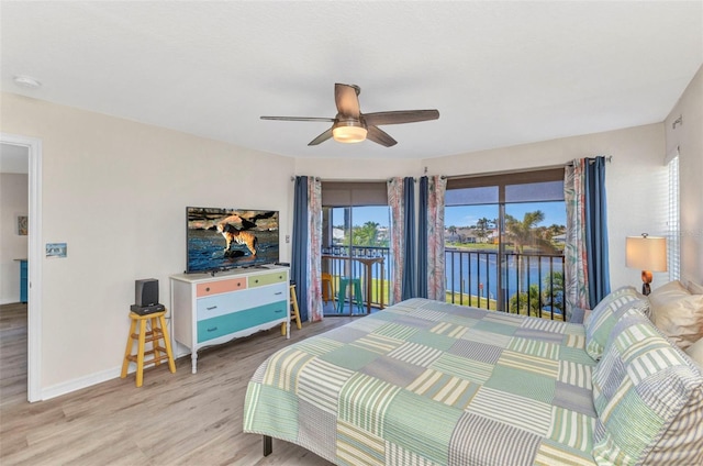 bedroom featuring ceiling fan, baseboards, wood finished floors, and access to outside