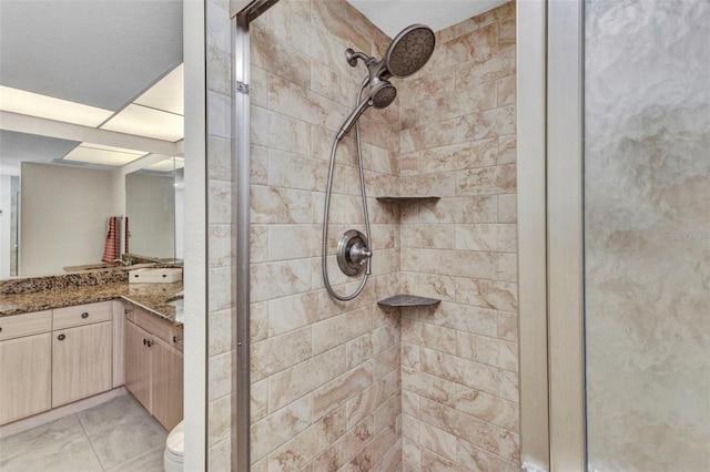 full bath with a stall shower and vanity