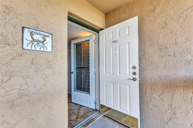 property entrance featuring stucco siding