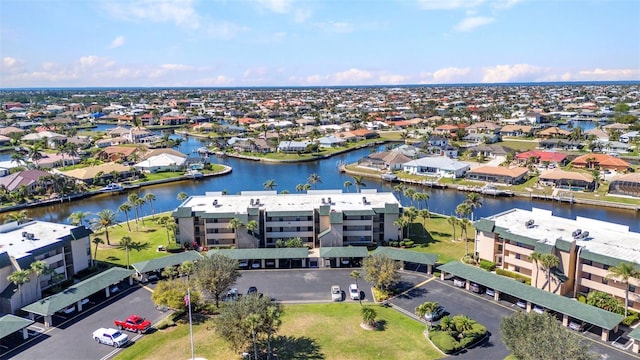 drone / aerial view featuring a residential view and a water view