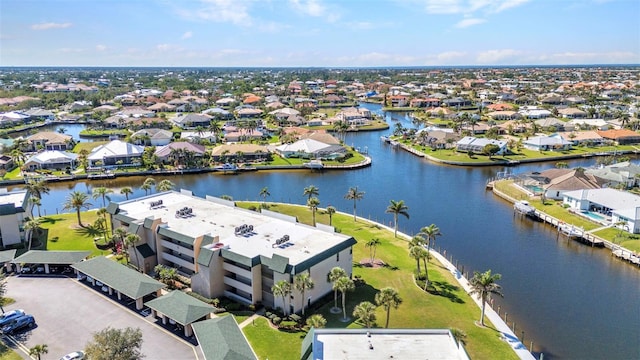 drone / aerial view featuring a residential view and a water view