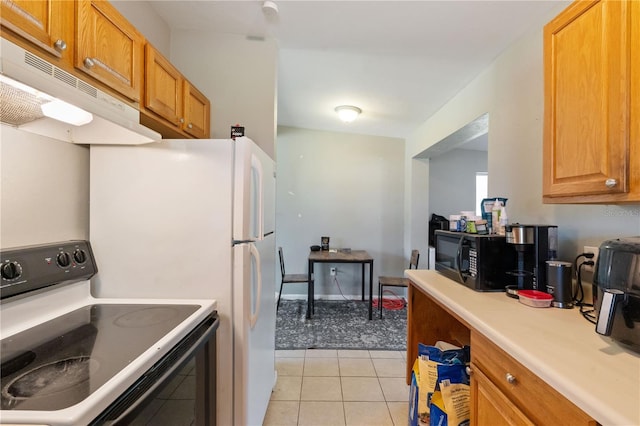 kitchen featuring black microwave, under cabinet range hood, light countertops, light tile patterned flooring, and electric range