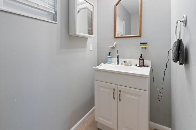 bathroom featuring tile patterned floors, baseboards, and vanity