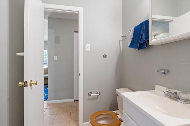 bathroom featuring tile patterned floors, baseboards, and vanity